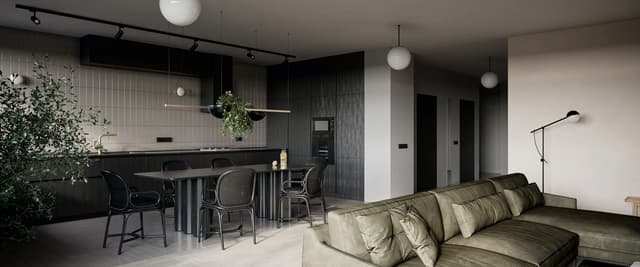Modern open-plan living space with sage green sofa, black kitchen island with bar seating, pendant lights, and potted plants